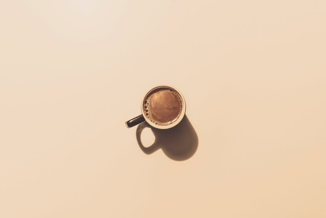 a cup of coffee on a minimalist surface